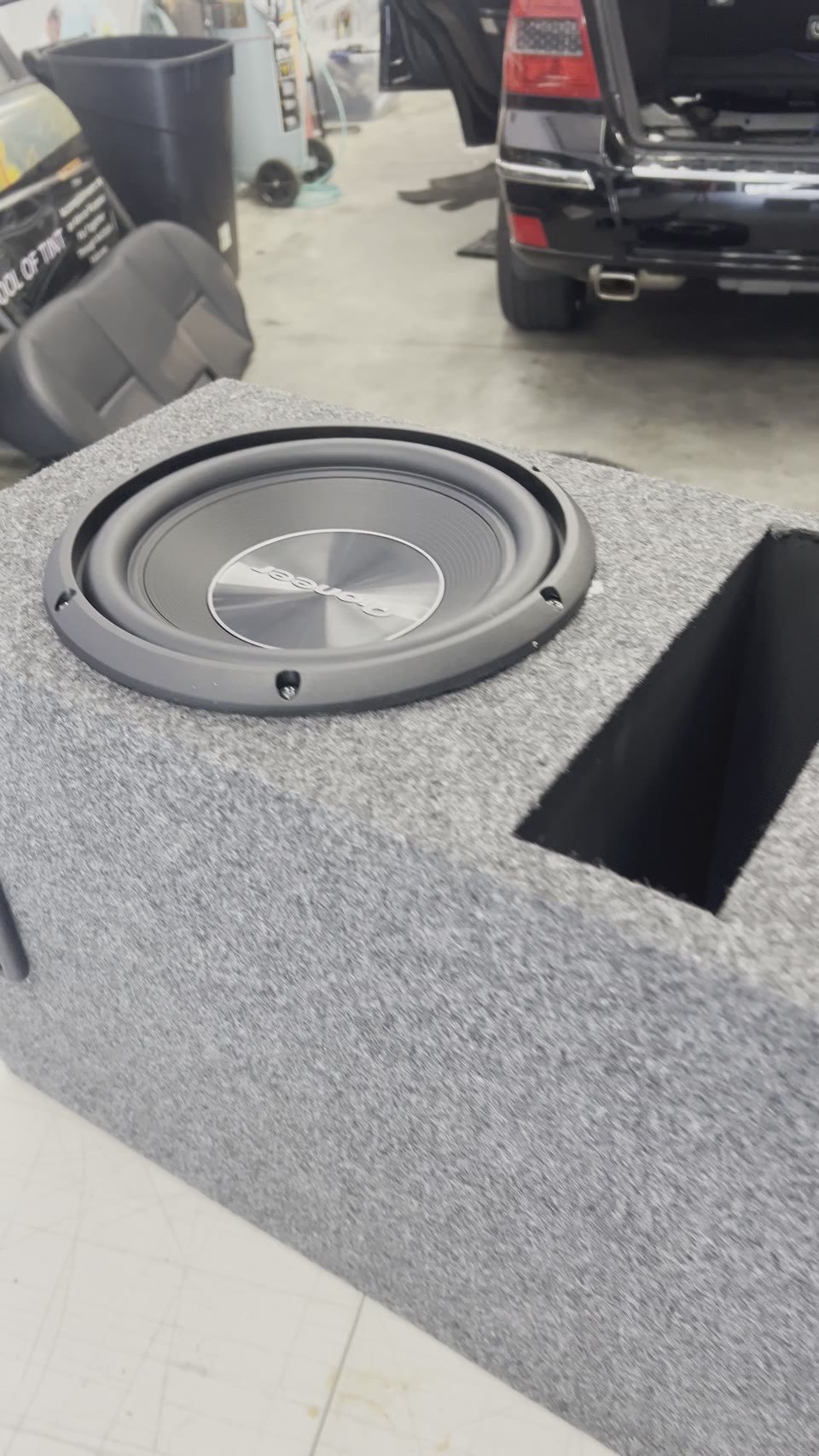 Subwoofer installed in a custom carpeted enclosure