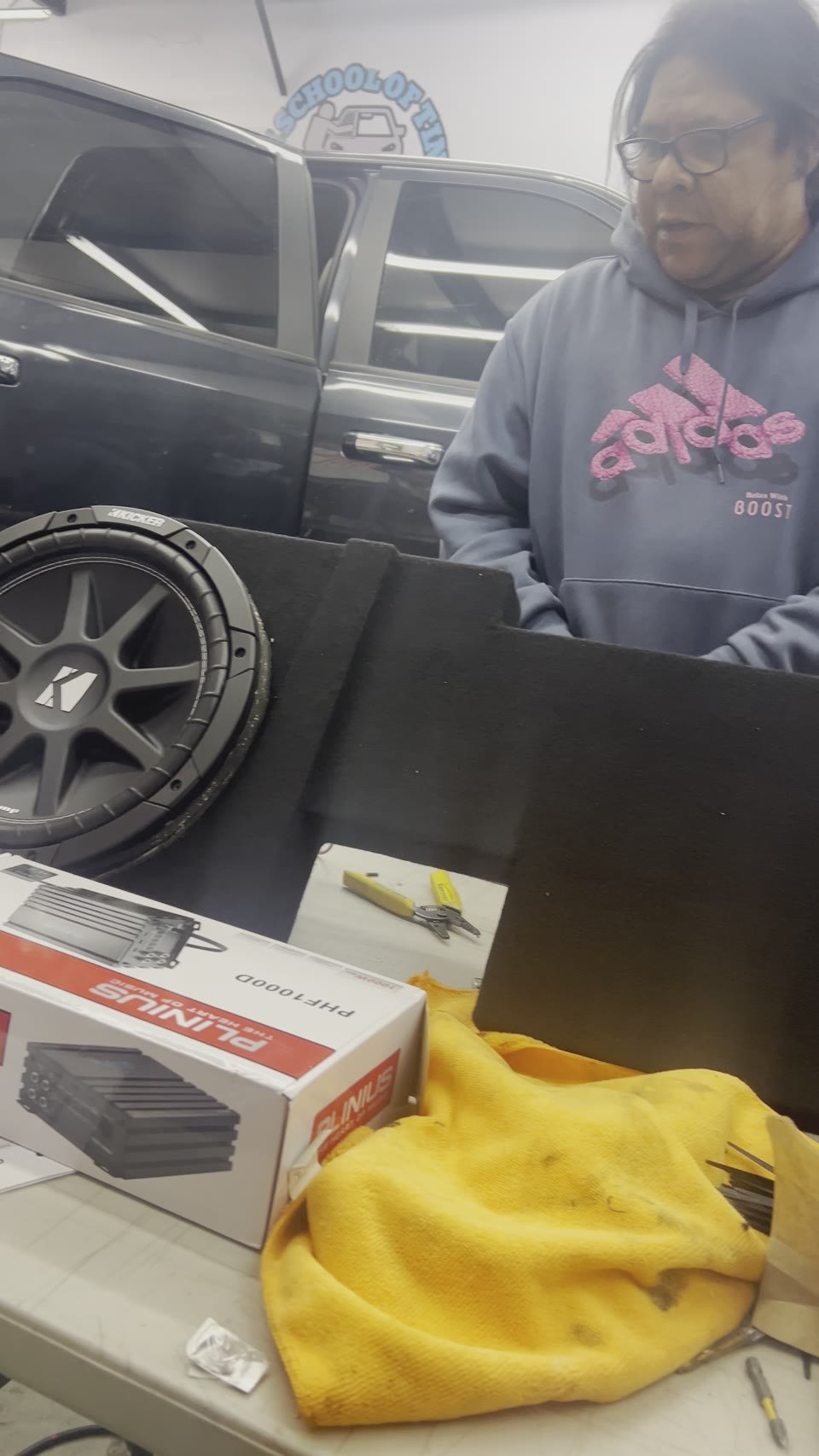 Kicker subwoofer being installed in a custom enclosure
