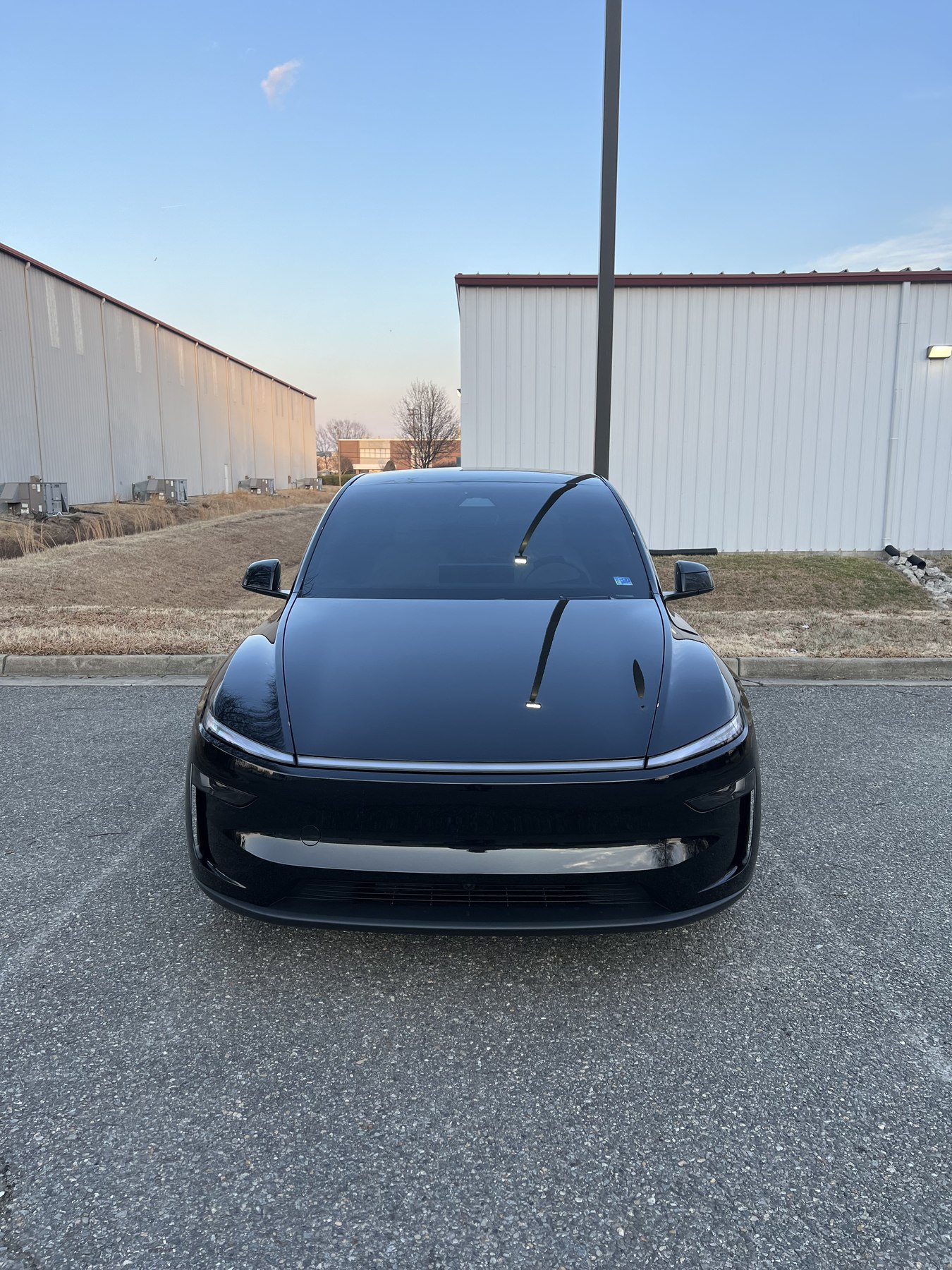 Front view of a black Lucid sedan showing its completed windshield and side glass appearance