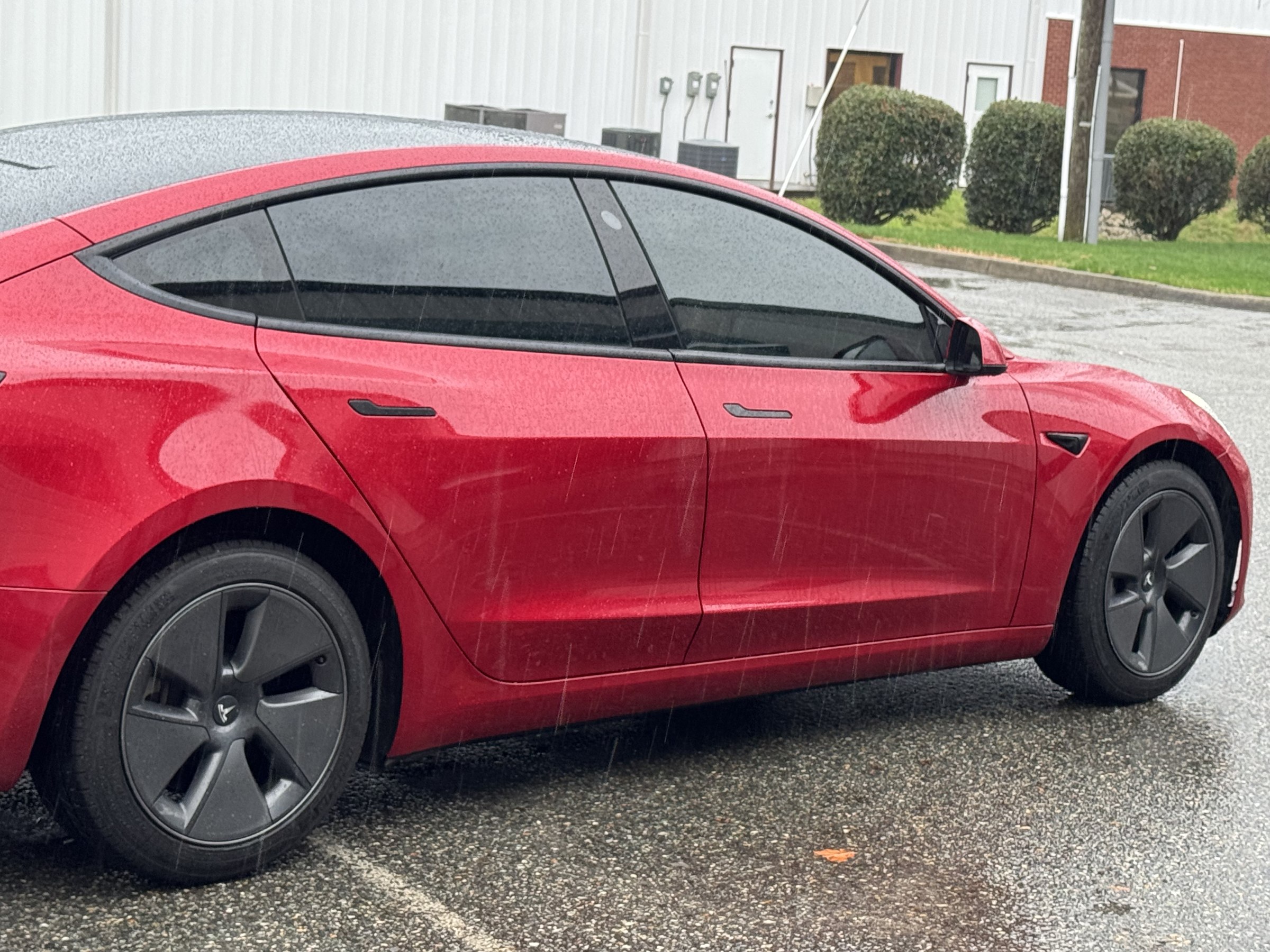 Red Tesla Model Y with professionally tinted side and rear windows