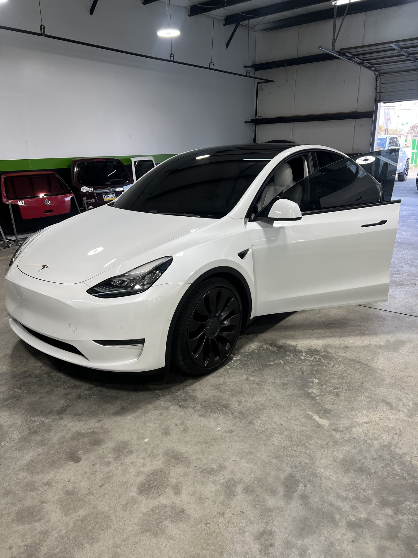 White Tesla Model Y with finished dark side and rear window tint