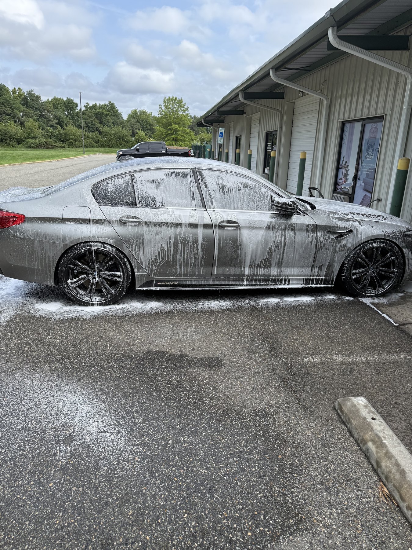 BMW covered in foam during ceramic coating decontamination