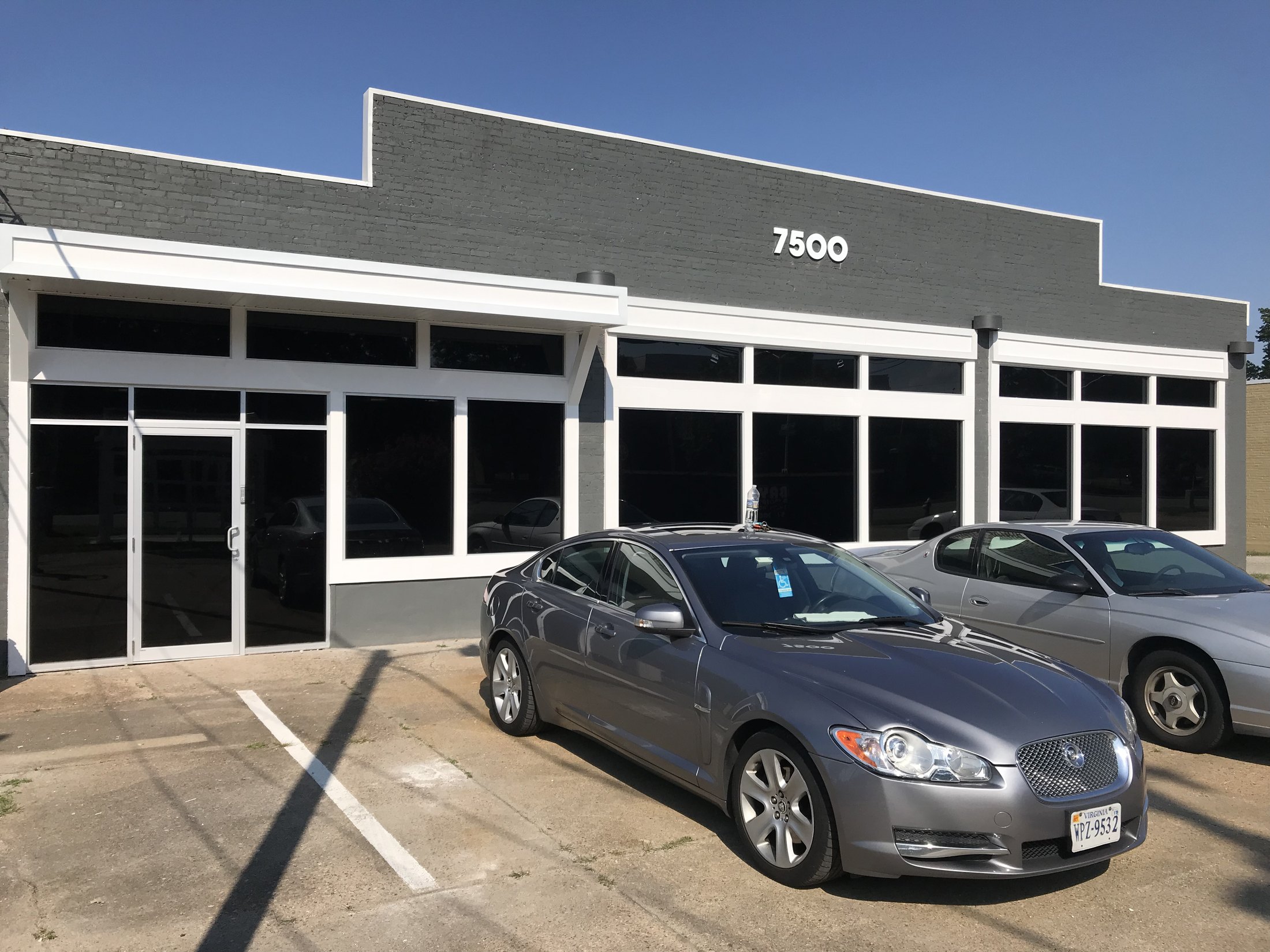 Completed dark solar window film across a large commercial storefront