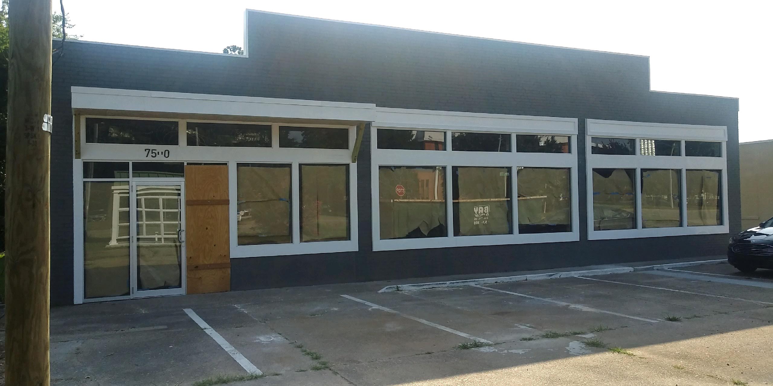 Commercial window film installed across a wide storefront facade
