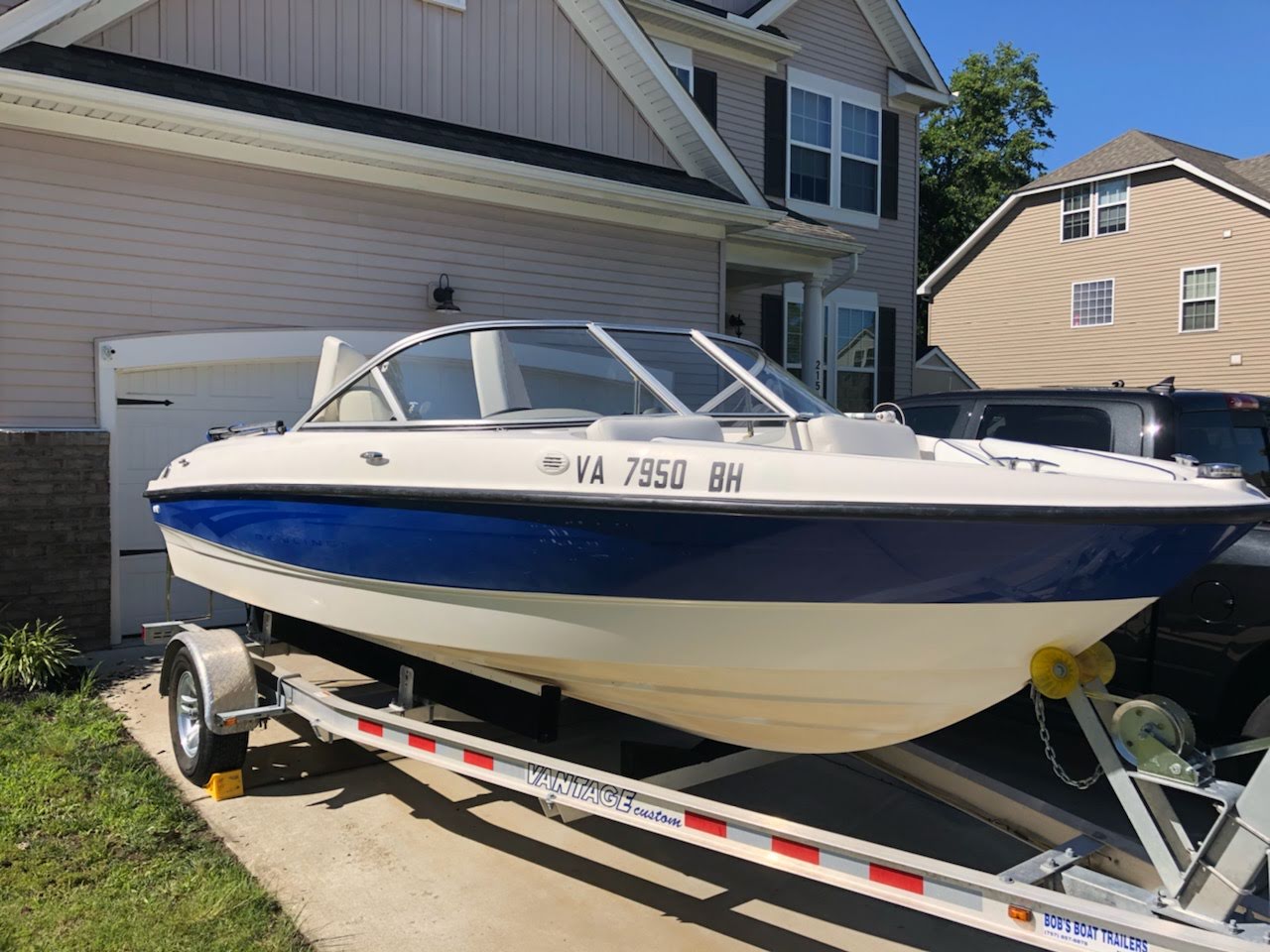 Blue and white boat with clear windshield glass before tint installation