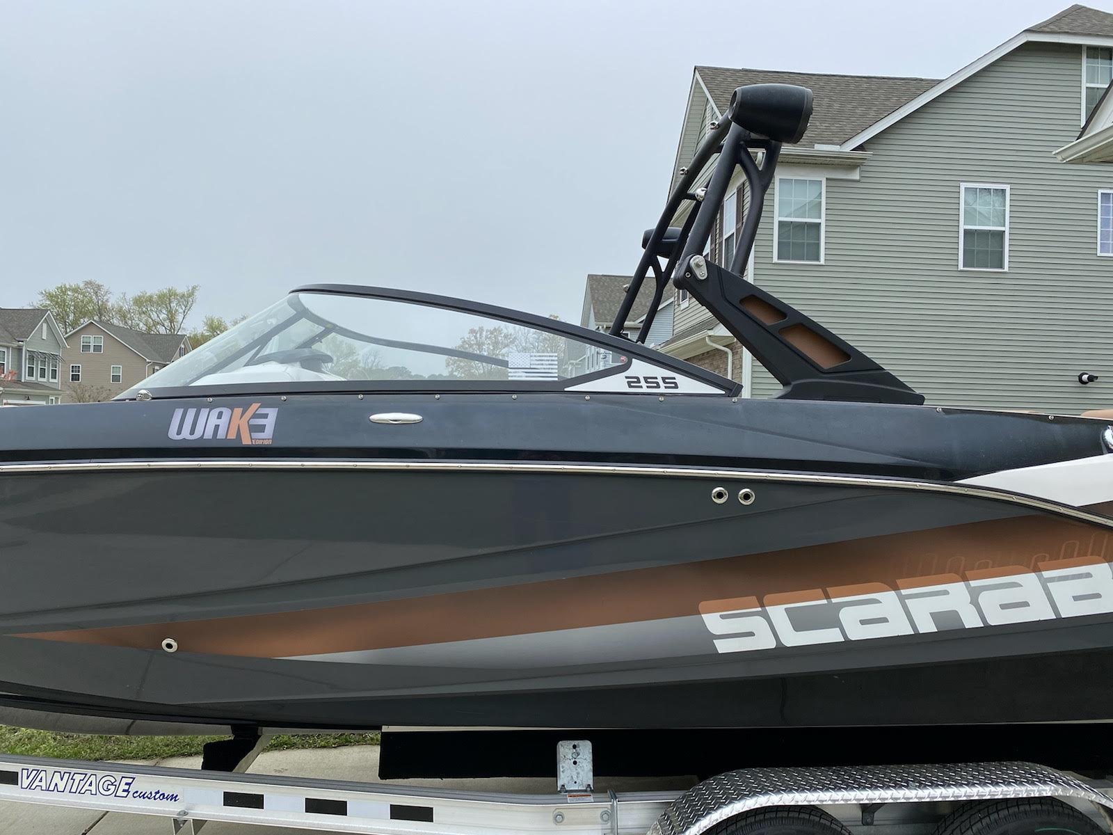 Side view of tinted windshield glass on a black wake boat