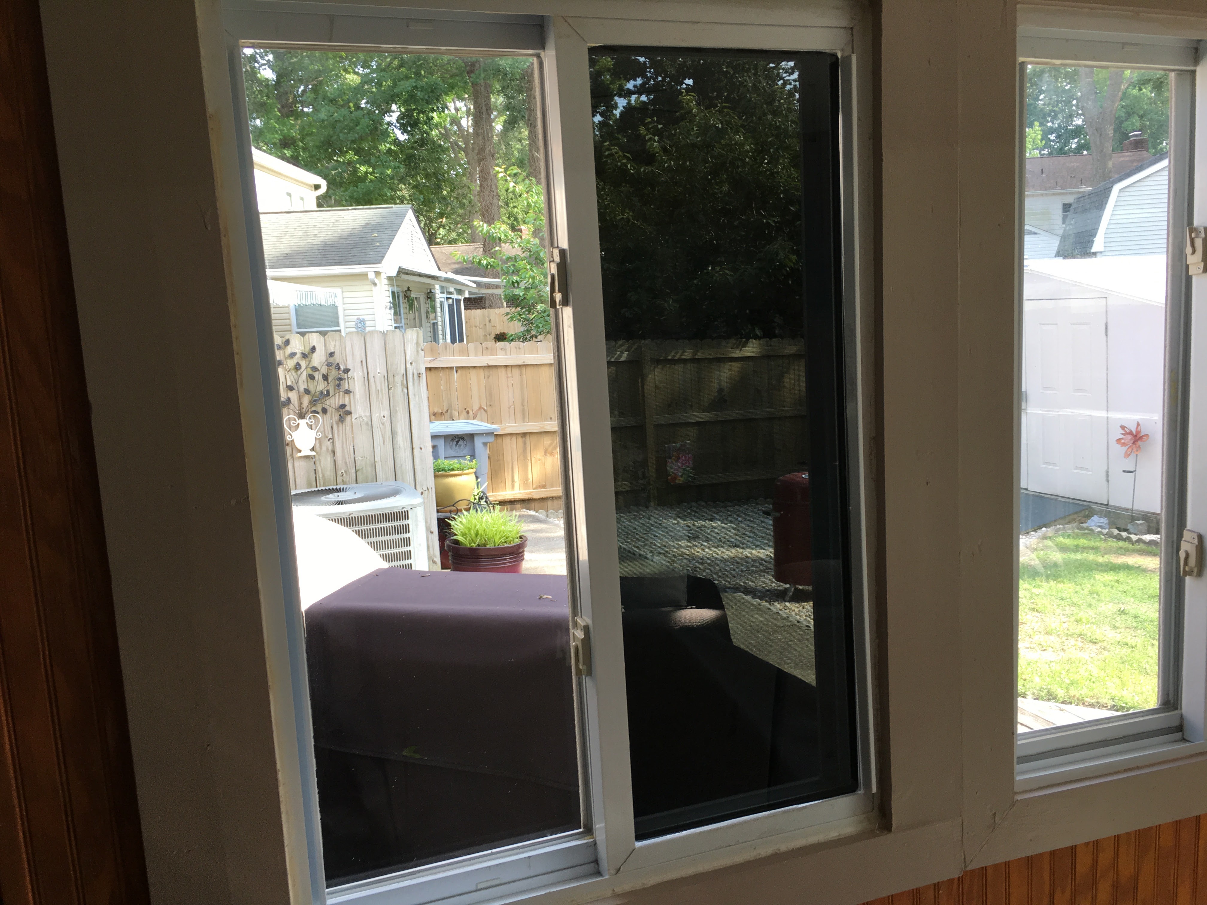 Side-by-side comparison of untreated residential glass and dark privacy window film