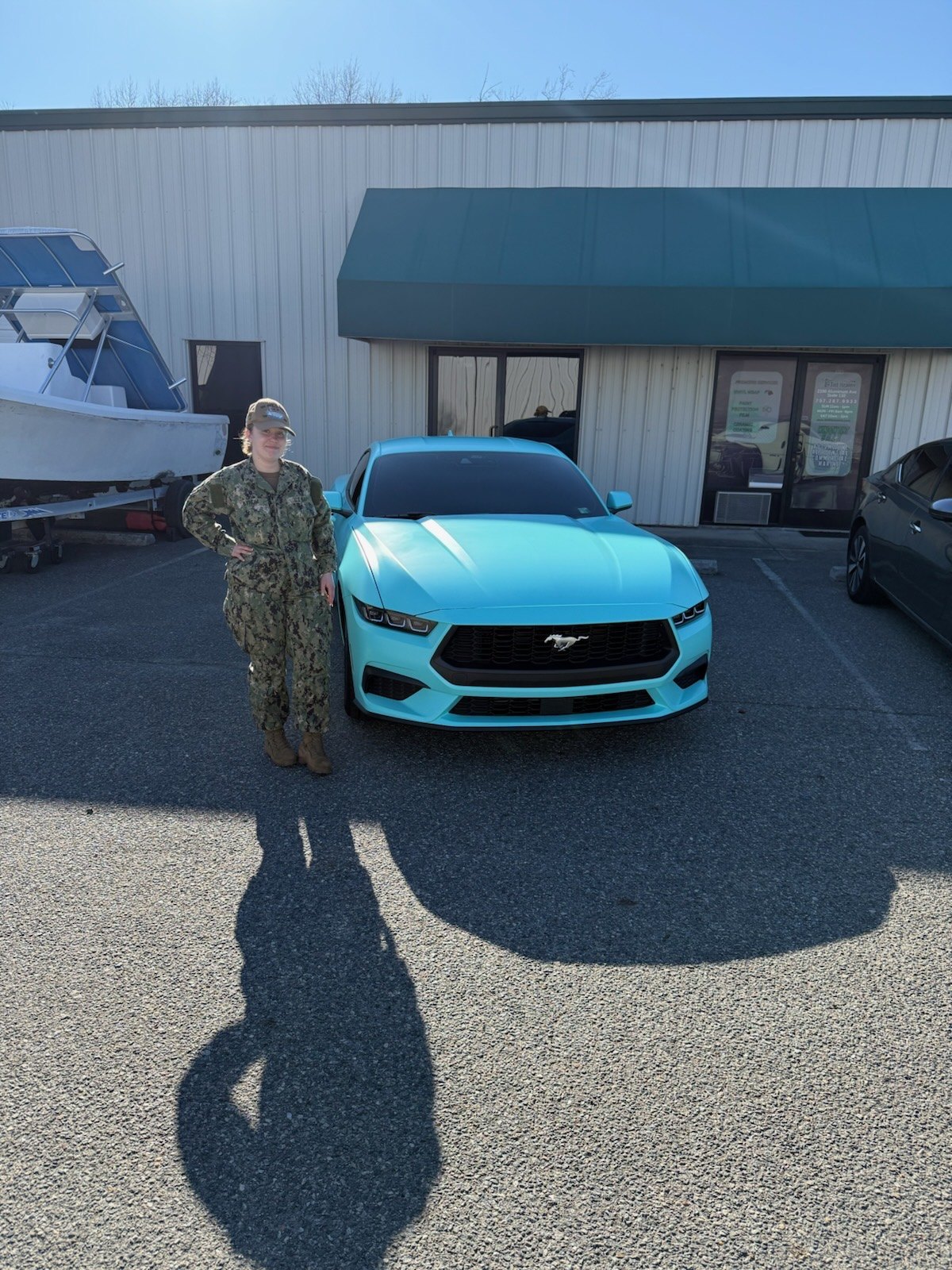 Customer picking up the completed mint wrapped Mustang