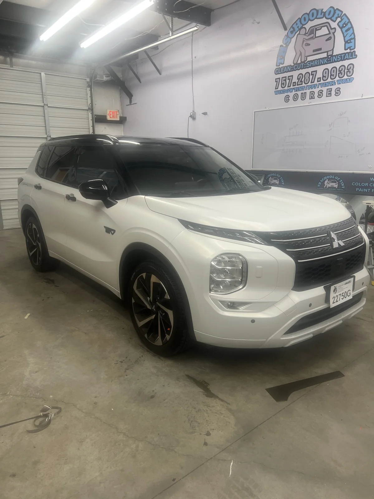 Satin Flip Ghost Pearl Mitsubishi Outlander from the opposite front angle