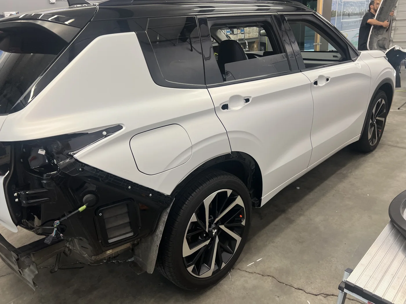 Outlander rear quarter with bumper trim removed during preparation