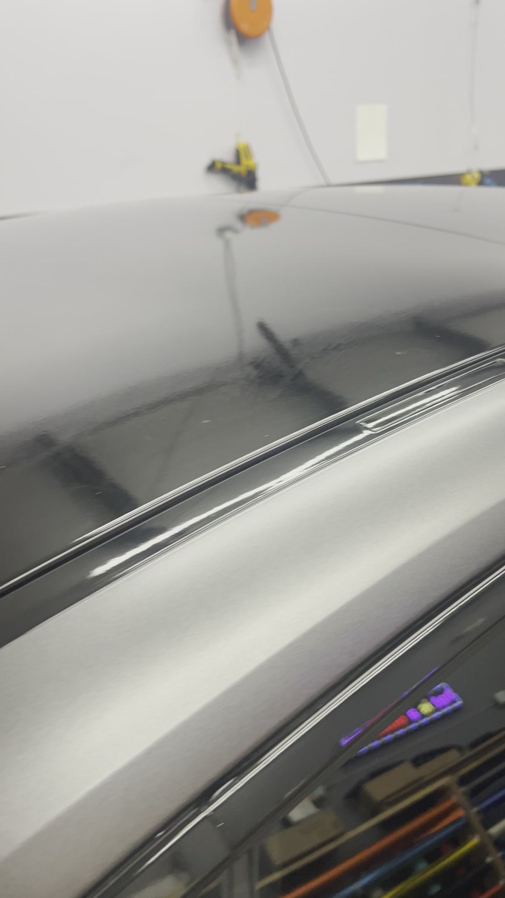 Close-up of a satin vinyl wrap surface and trim edge