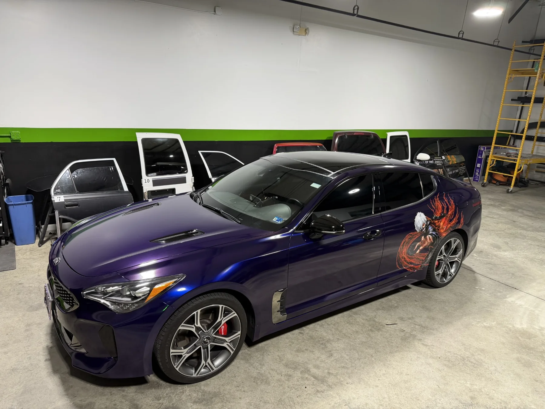 Purple 2020 Kia Stinger with custom anime artwork, viewed from the front quarter