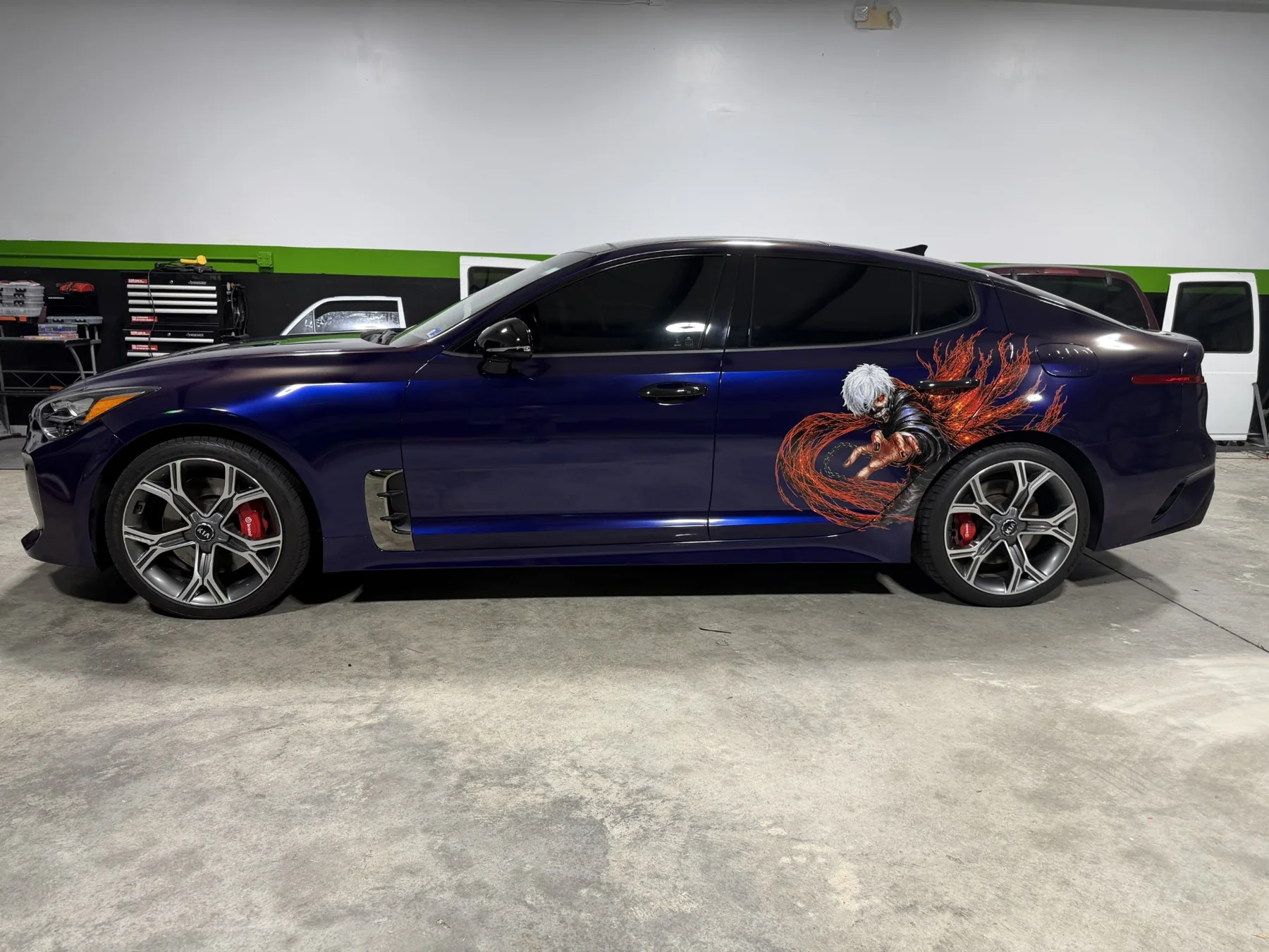 Full side profile of the purple Kia Stinger with anime artwork on the rear quarter