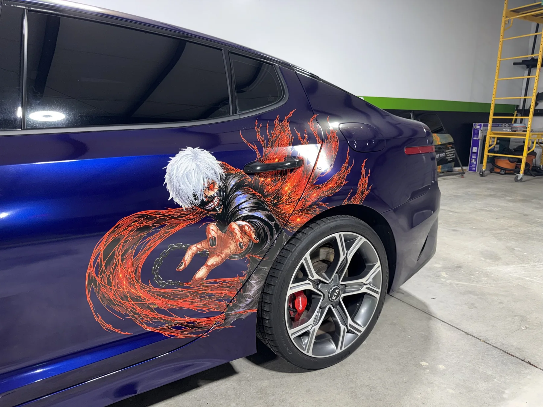 Close detail of the anime artwork on the purple Kia Stinger
